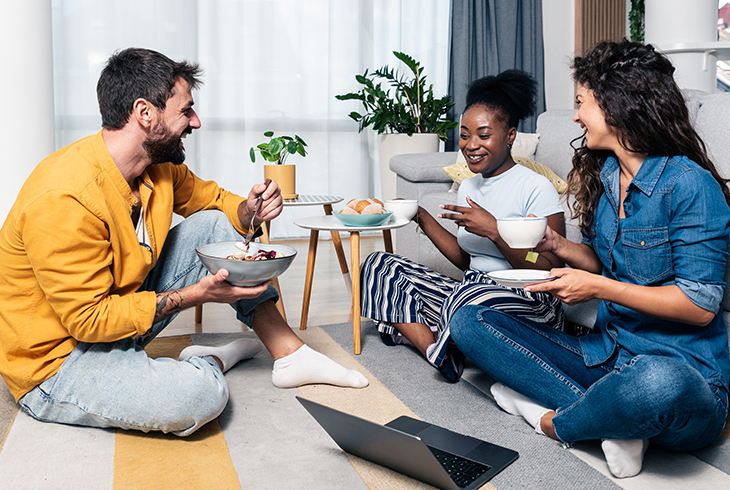 people sitting on ground eating food