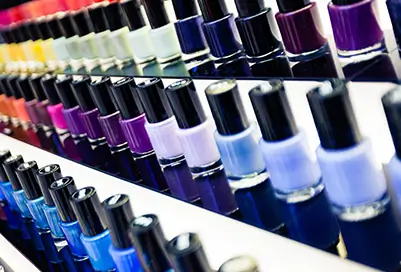 Various shades of nail polish on three tier display.